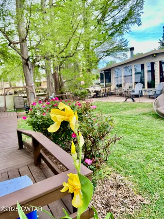 a view of a patio with a table and chairs and potted plants