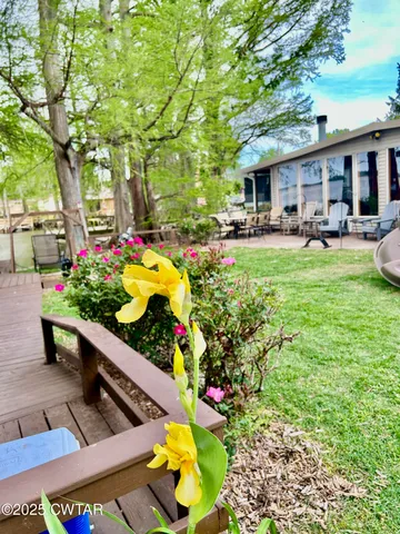 a view of a patio with a table and chairs and potted plants
