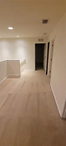 an empty room with a fireplace and a window