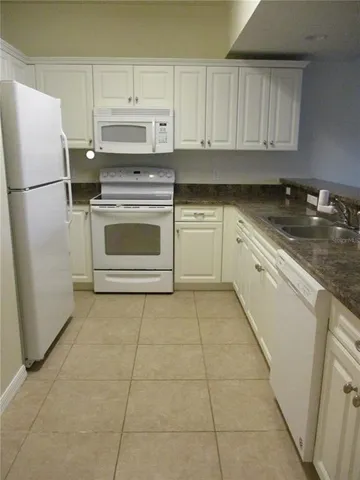 a kitchen with cabinets and white stainless steel appliances