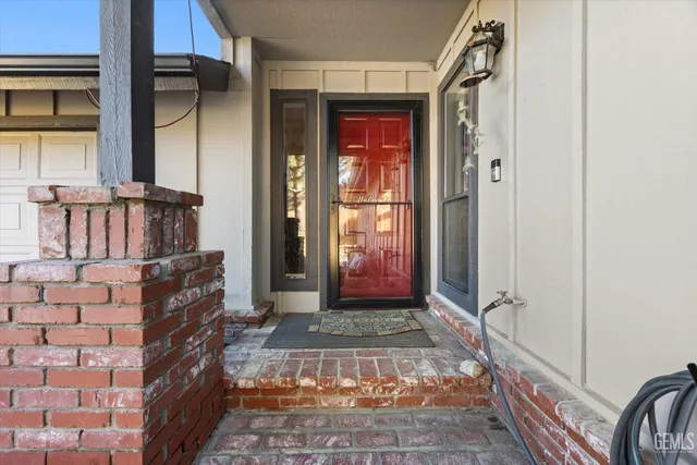 a living room with furniture a fireplace and a large window
