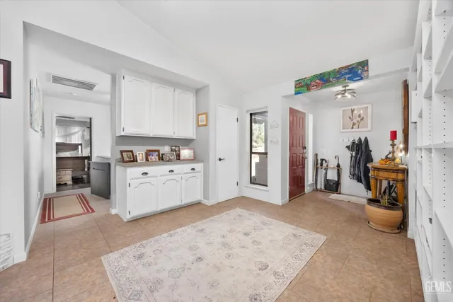 a bedroom with furniture and a large window