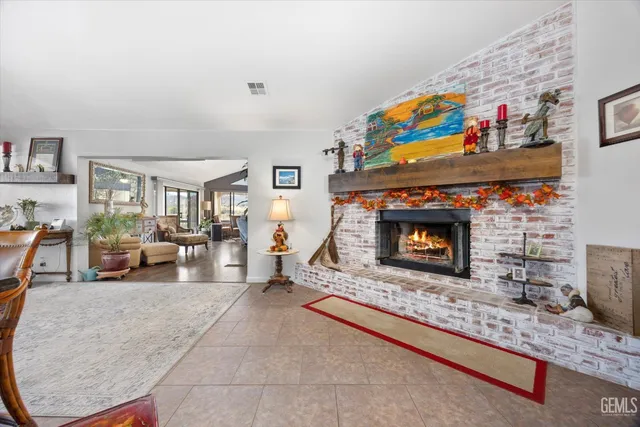 a living room with furniture kitchen view and a large window