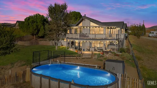 a view of a house with a backyard and a swimming pool
