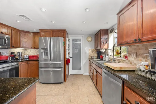 a bathroom with a double vanity sink mirror and toilet