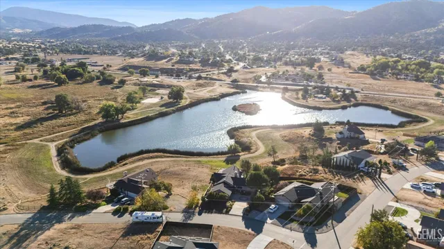 a large white kitchen with refrigerator stove and a sink