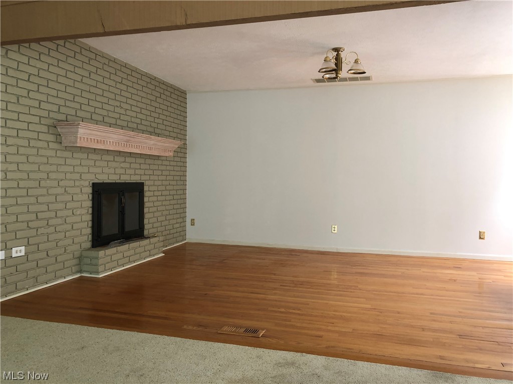 35236 Martin Road Willoughby, OH 44094 - Photo 19 of 35 Living room with brick wall and light carpet