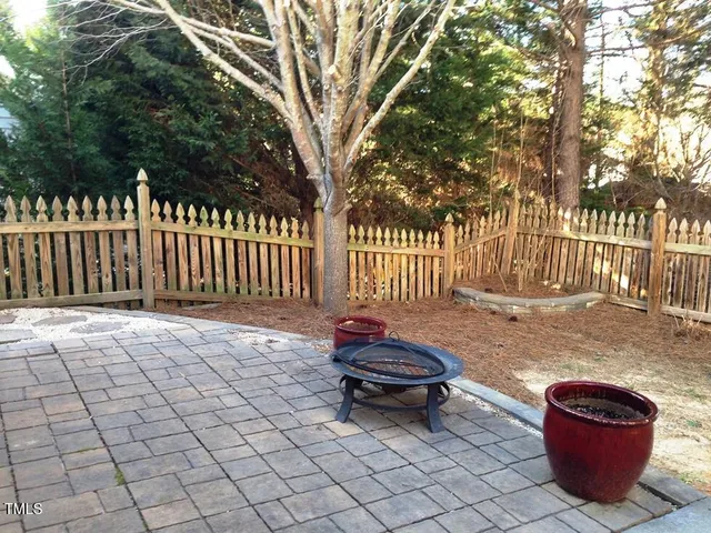 a backyard of a house with barbeque oven and outdoor seating