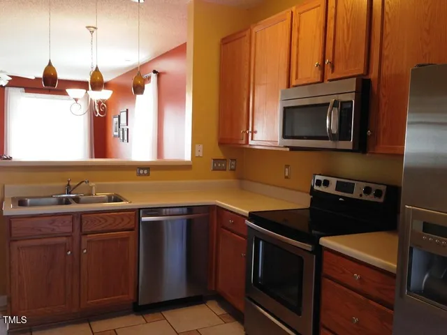 a kitchen with stainless steel appliances a stove a sink and a microwave