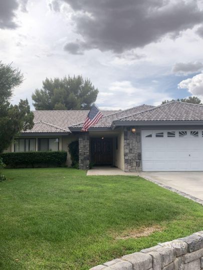 909 Cimarron Court Ridgecrest, CA 93555 - Photo 2 of 6 a view of a yard in front of a house