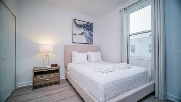 a bedroom with a bed and a night stand