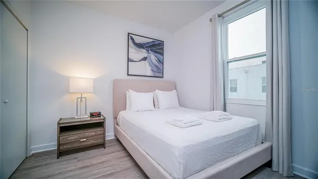 a bedroom with a bed and a night stand