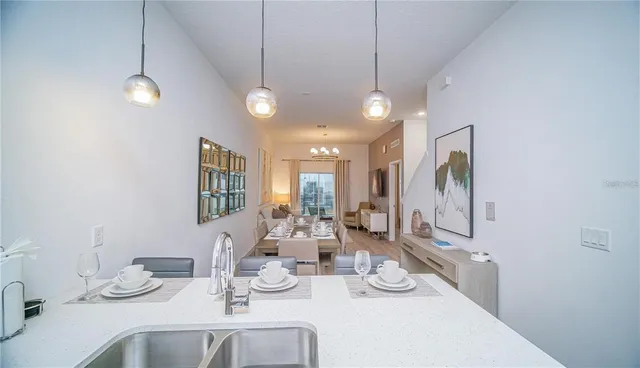 a view of a dining room with furniture large window and wooden floor