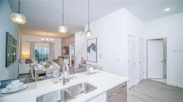 a view of a kitchen area with furniture and wooden floor