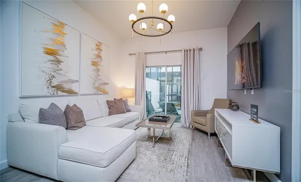 a living room with furniture and a large window