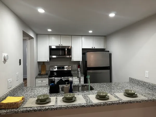 a kitchen with sink and refrigerator
