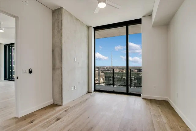 wooden floor in an empty room with windows and balcony