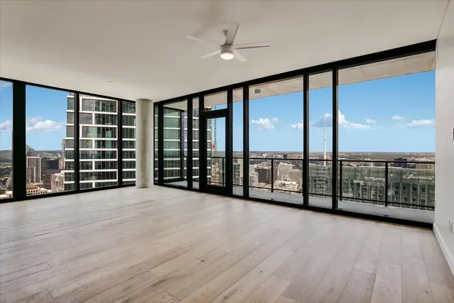wooden floor in an empty room with a large window