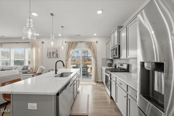 a kitchen with counter top space a sink stainless steel appliances and cabinets