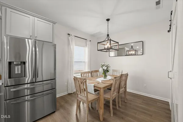 a kitchen with stainless steel appliances a refrigerator and wooden floor