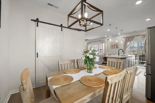 a dining room with furniture and a chandelier