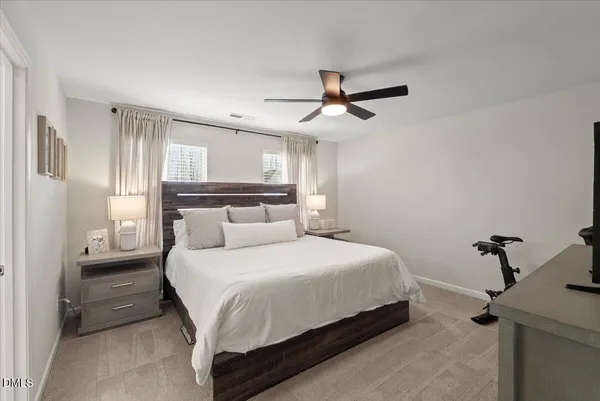 a bedroom with a bed and a ceiling fan