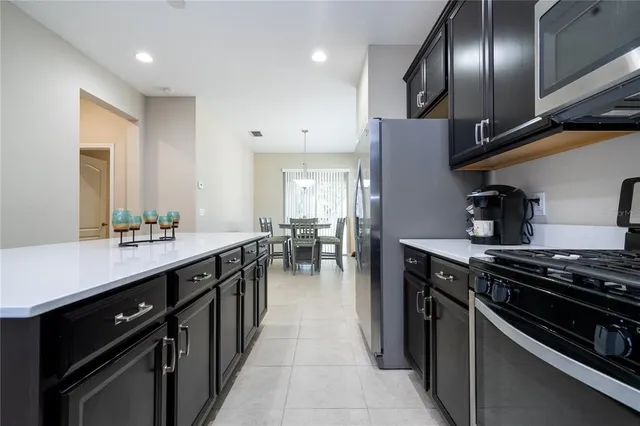 a kitchen with a sink appliances and cabinets