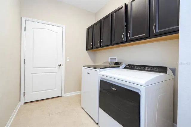 a bedroom with a bed and a potted plant