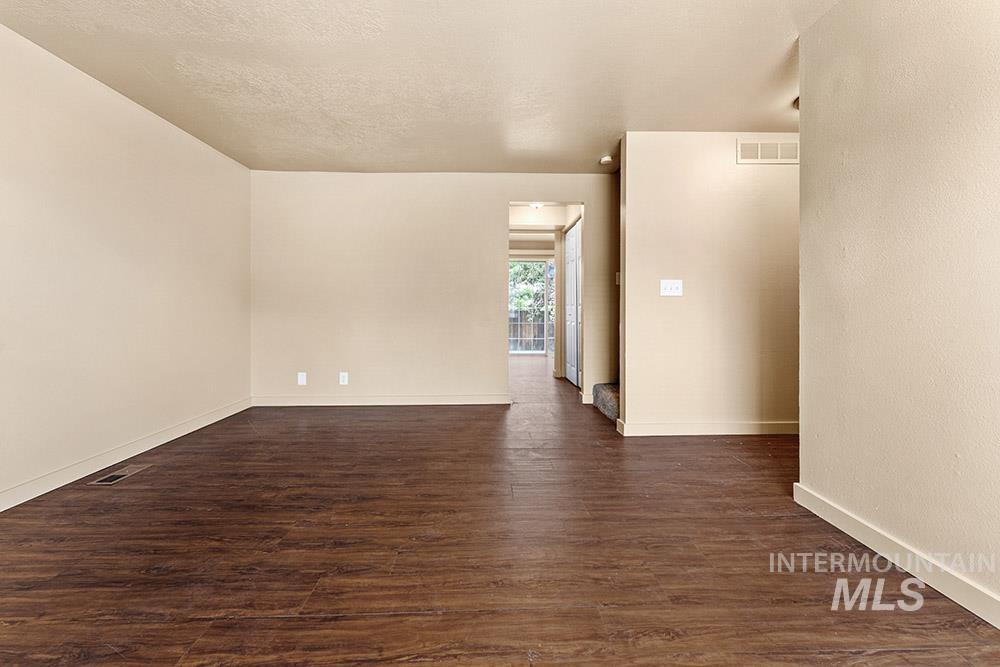 4806 Richardson Street Boise, ID 83705 - Photo 6 of 19 Spare room featuring dark wood finished floors, a textured ceiling, and a textured wall