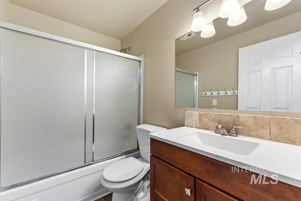 4806 Richardson Street Boise, ID 83705 - Photo 10 of 19 Bathroom with vanity, tasteful backsplash, and enclosed tub / shower combo