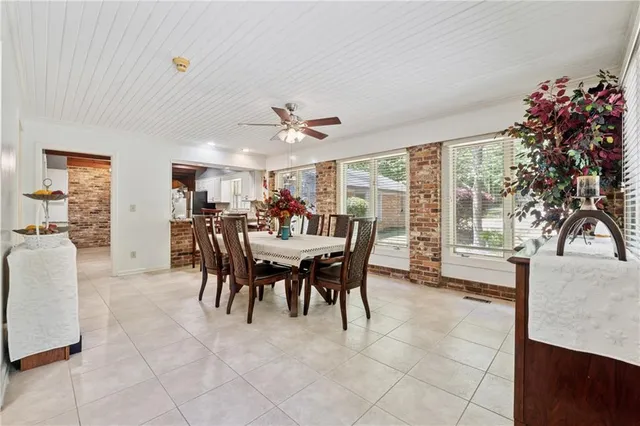 a view of a dining room with furniture and a potted plant