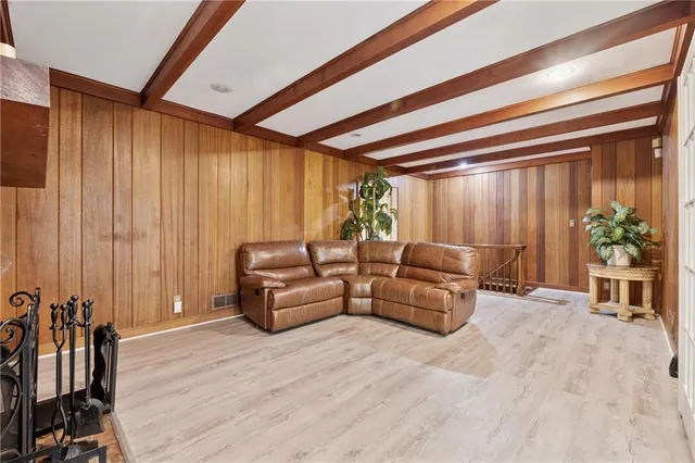 a living room with furniture and large windows