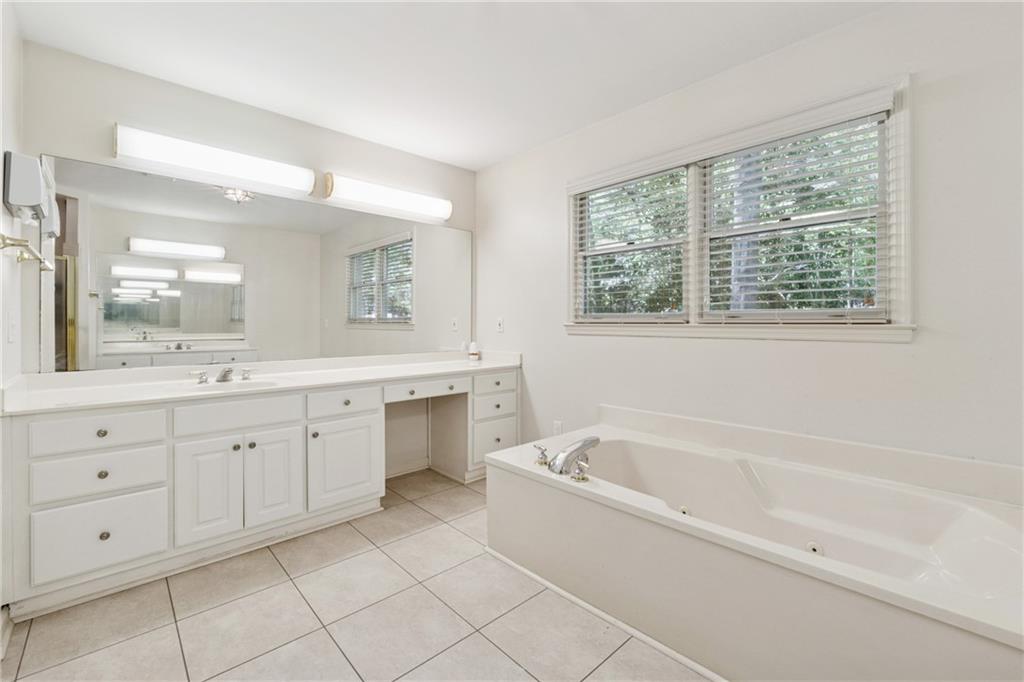1387 Springdale Road Gainesville, GA 30501 - Photo 23 of 49 a spacious bathroom with a granite countertop sink mirror and a bathtub