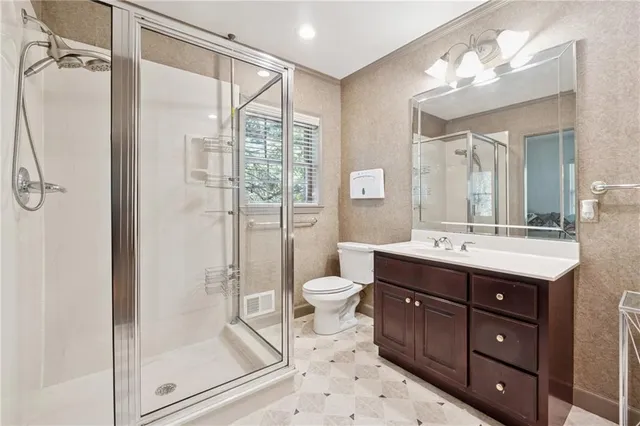 a bathroom with a double vanity sink mirror and toilet
