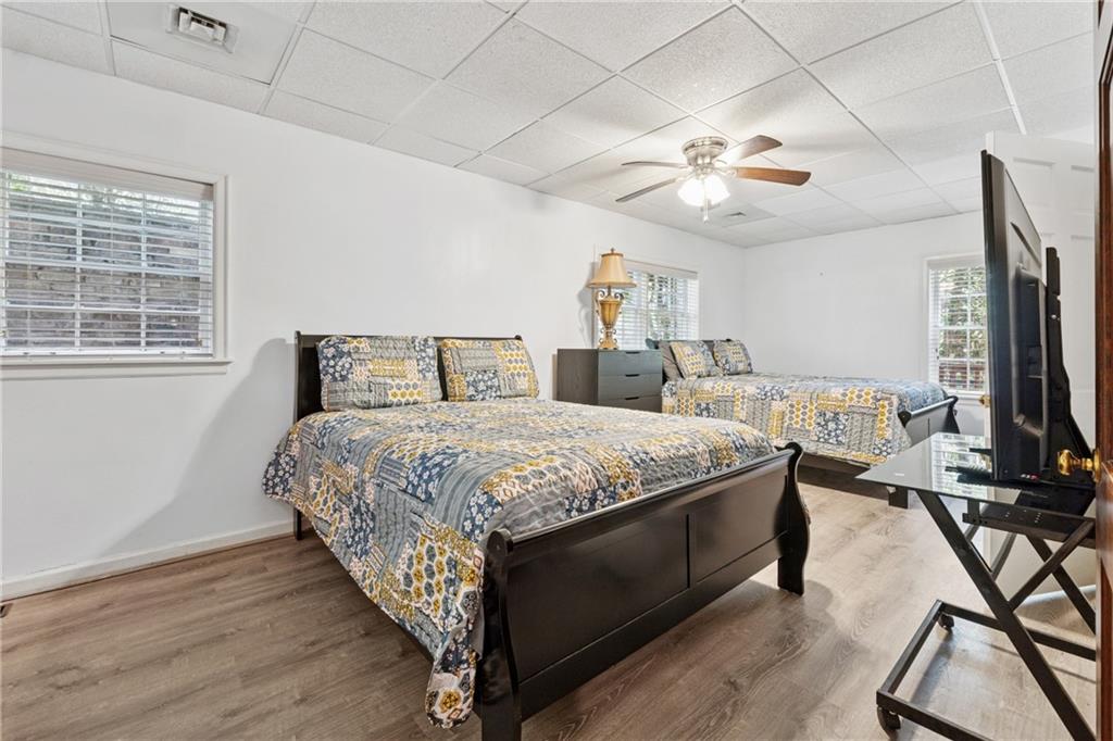 1387 Springdale Road Gainesville, GA 30501 - Photo 31 of 49 a bedroom with a bed and a flat screen tv