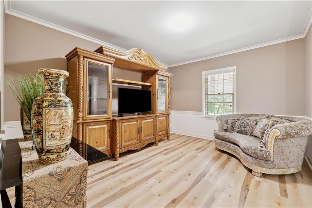 1387 Springdale Road Gainesville, GA 30501 - Photo 7 of 49 a living room with furniture and a flat screen tv