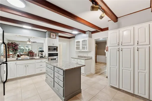 a kitchen with white cabinets and white appliances