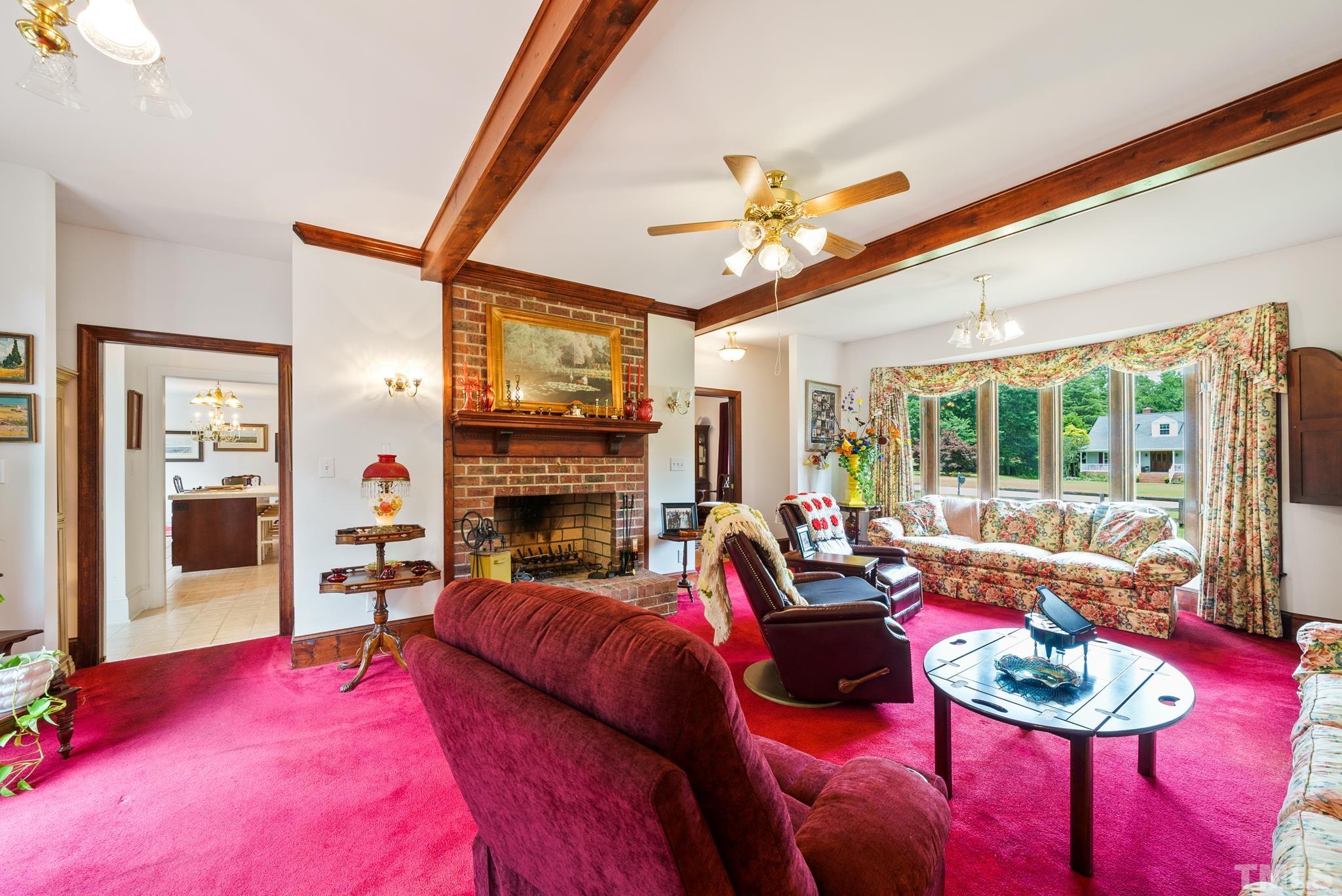 920 Windrow Lane Raleigh, NC 27603 - Photo 13 of 40 a living room with furniture and a fireplace