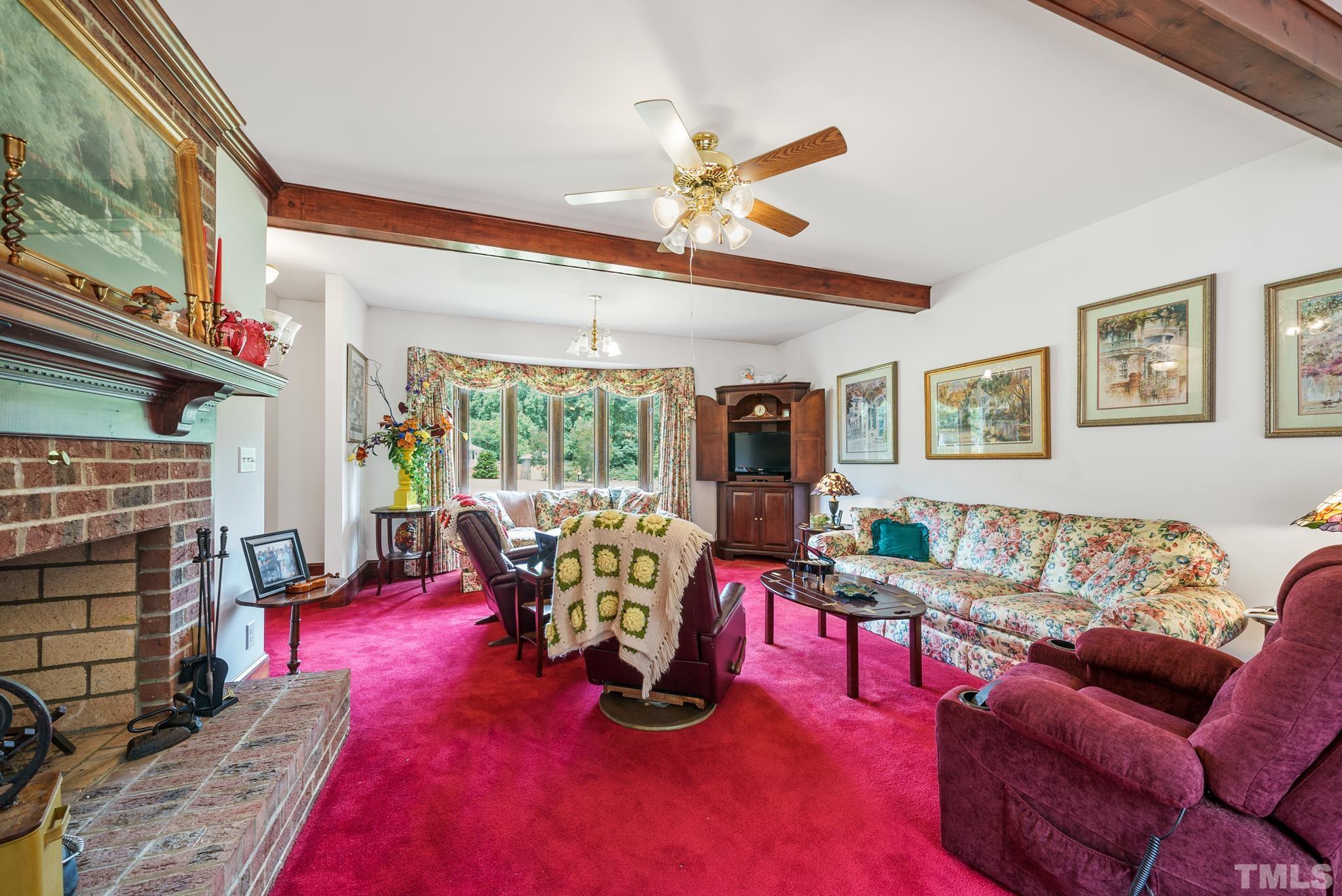 920 Windrow Lane Raleigh, NC 27603 - Photo 15 of 40 a living room with furniture a rug and a fireplace