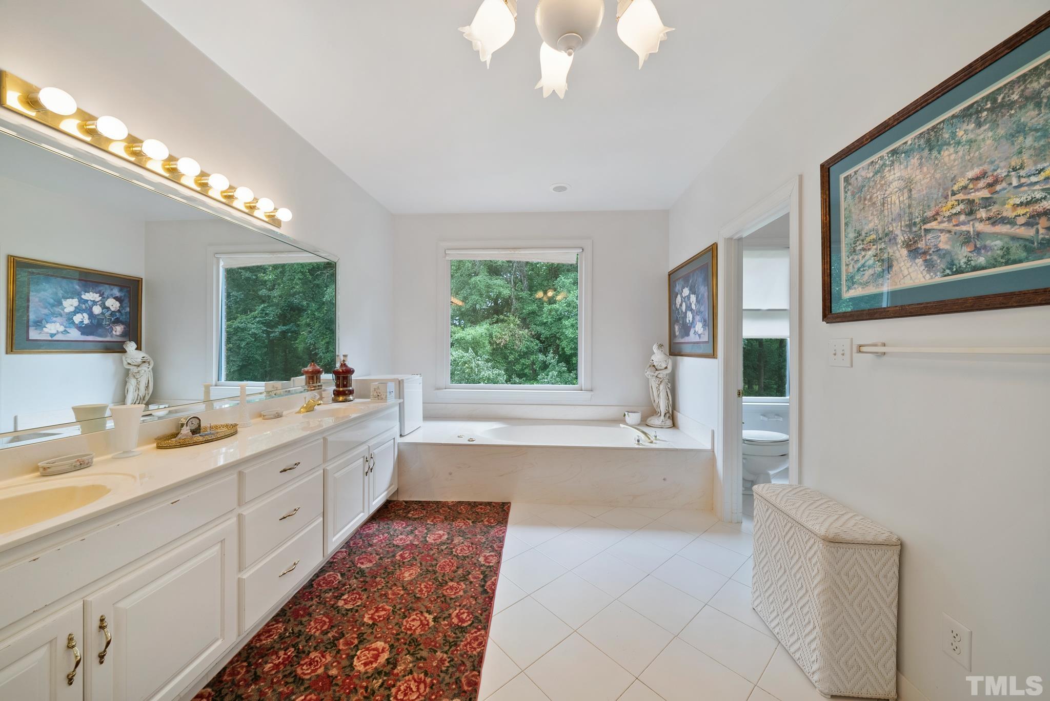 920 Windrow Lane Raleigh, NC 27603 - Photo 23 of 40 a large white kitchen with a large window