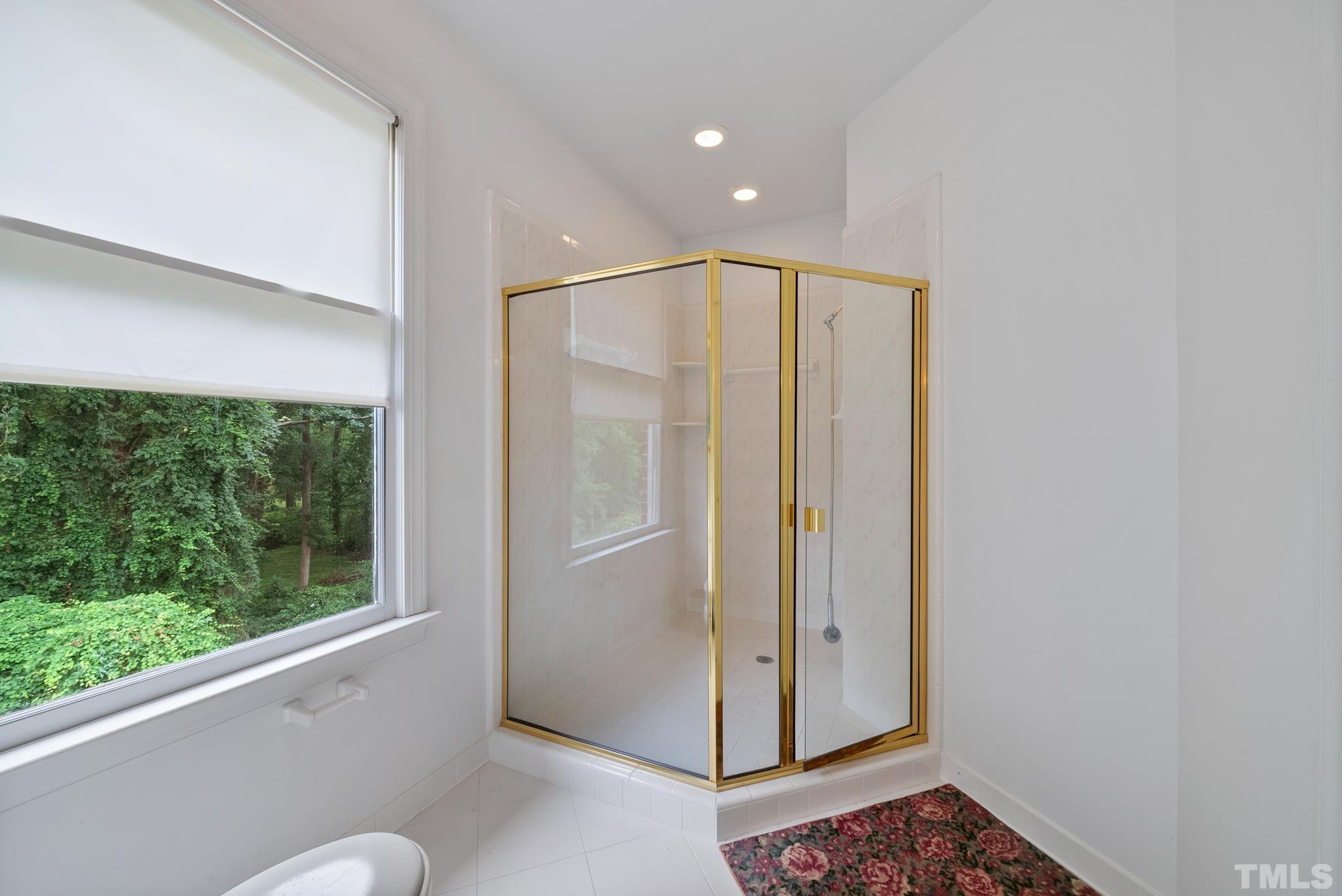 920 Windrow Lane Raleigh, NC 27603 - Photo 24 of 40 a bathroom with a glass shower door