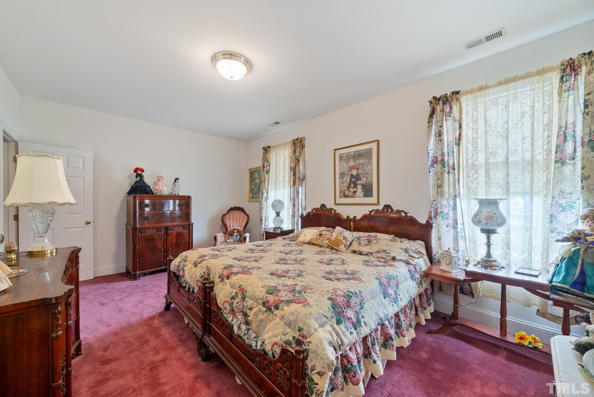 920 Windrow Lane Raleigh, NC 27603 - Photo 26 of 40 a bedroom with a bed and a lamp on dresser