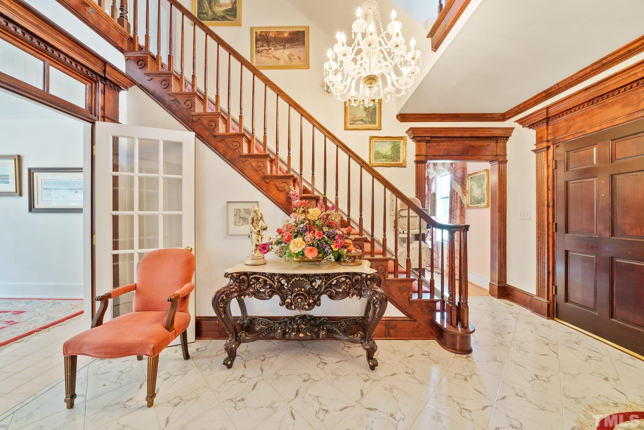 920 Windrow Lane Raleigh, NC 27603 - Photo 4 of 40 a view of staircase with furniture and a chandelier