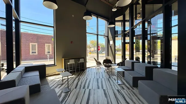 a living room with furniture fireplace and large windows