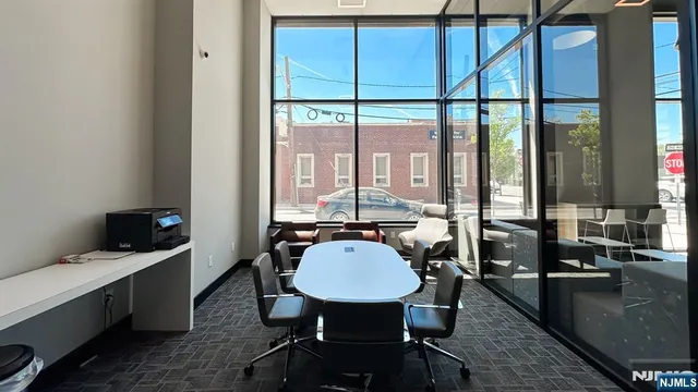 a view of a workspace with furniture and window