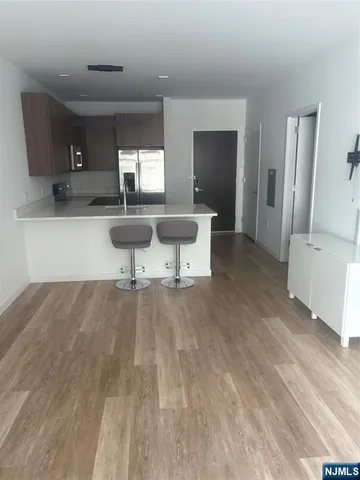a view of living room with furniture and wooden floor