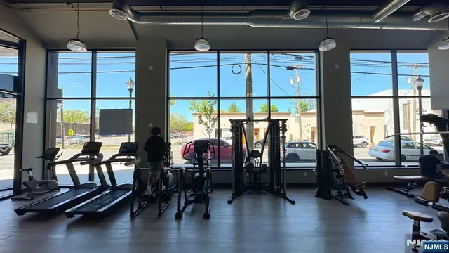 a living room with furniture and floor to ceiling window