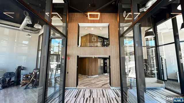a view of hallway with wooden floor and a fireplace