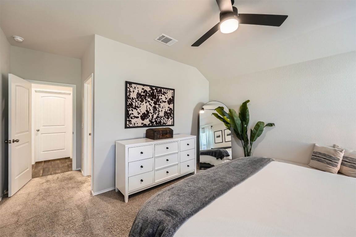 6404 Diamondleaf Bend Austin, TX 78724 - Photo 14 of 29 Bedroom featuring carpet, a ceiling fan, and vaulted ceiling