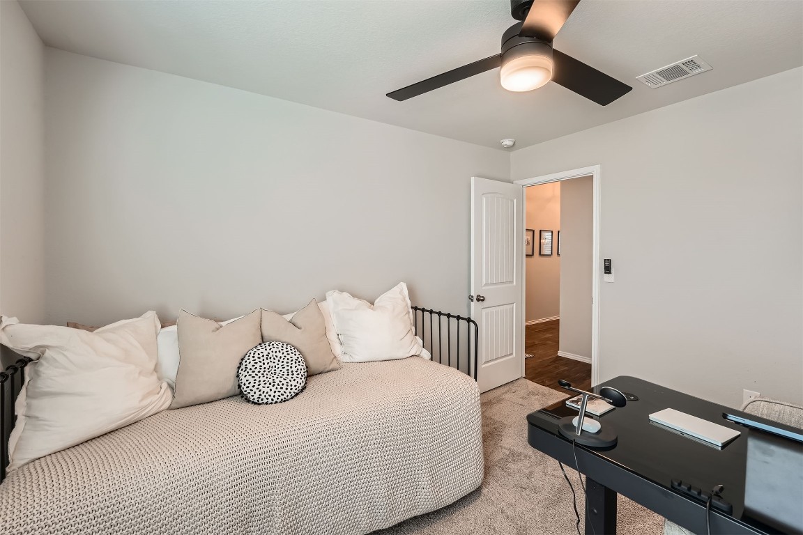 6404 Diamondleaf Bend Austin, TX 78724 - Photo 18 of 29 Bedroom with ceiling fan, light carpet, and a desk